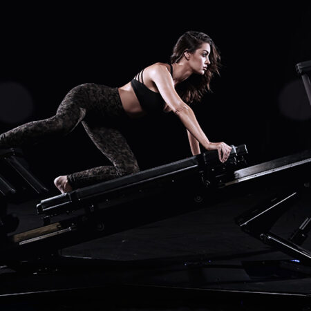 A woman is working out on the gym equipment.