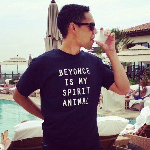 A man wearing sunglasses and a t-shirt that says " beyonce is my spirit animal ".
